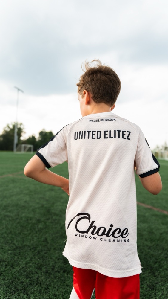 A player seen from behind in a United Elitez jersey with the Choice Window Cleaning sponsor logo