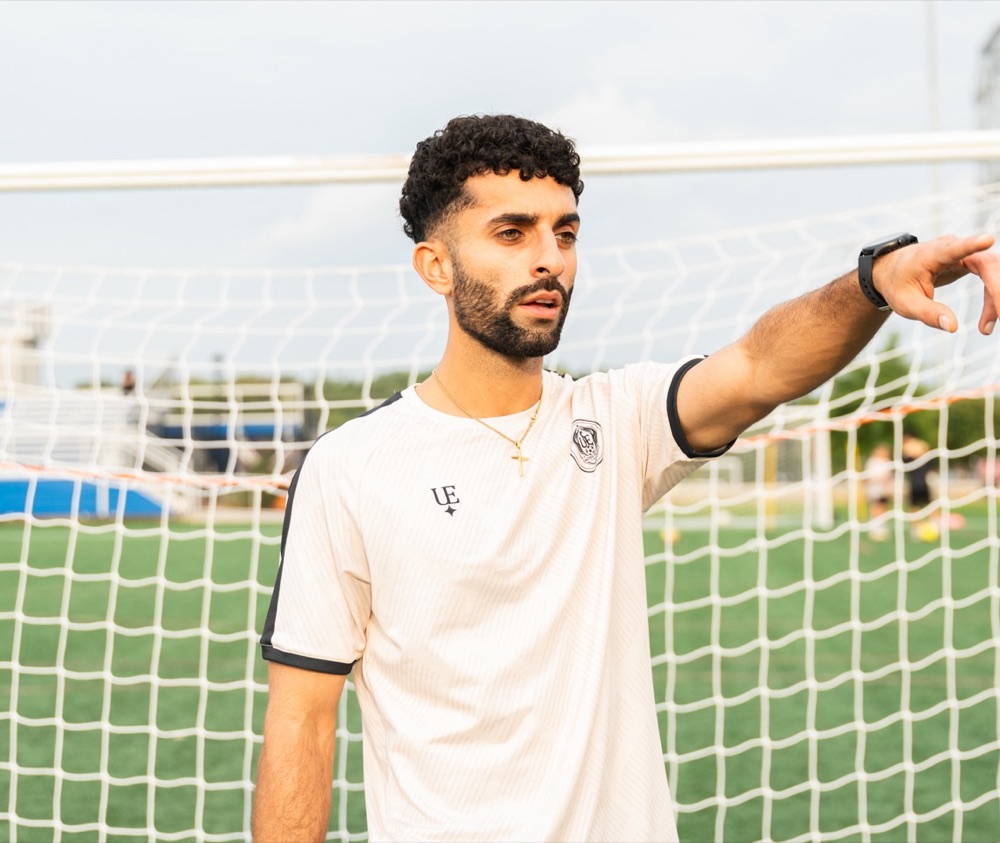 Coach Parsa pointing out instructions during a training session